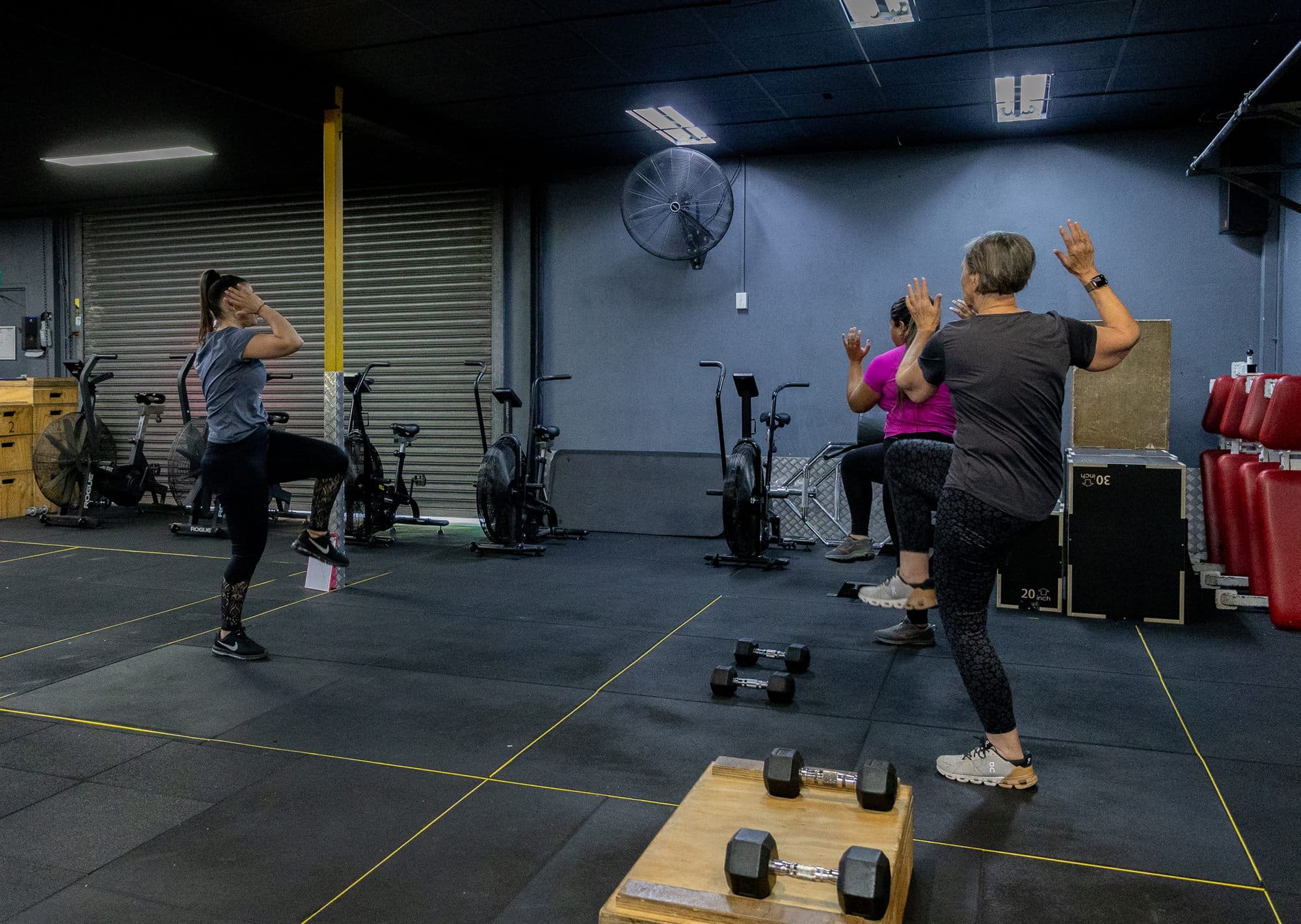 A quiet corner of the gym floor with two women part way through a session
